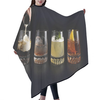 Personality  Girl Bartender Pours Cream And Prepares A Set Of Classic Cold Alcoholic Cocktails In Transparent Glasses On A Black Background. White Russian, Bramble, Whiskey Sour And Negroni. Hair Cutting Cape