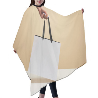 Personality  Cropped Image Of Woman Holding White Shopping Bag Above White Table Isolated On Beige Hair Cutting Cape