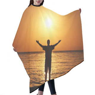 Personality  A Man On The Beach Welcomes The Sunrise. Hands Are Spread Apart. Hair Cutting Cape