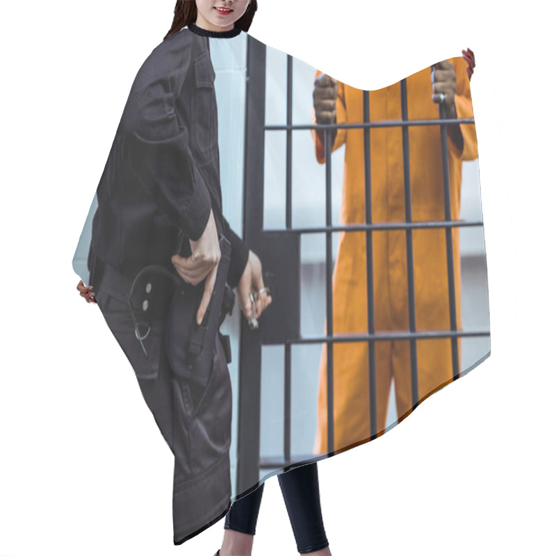 Personality  Cropped Image Of Prison Guard Putting Hand On Gun Near Prison Bars Hair Cutting Cape