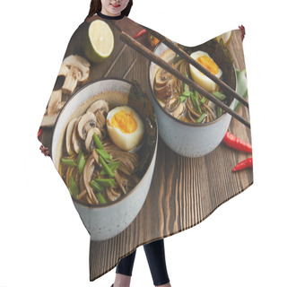 Personality  Traditional Spicy Ramen In Bowls With Chopsticks And Vegetables On Wooden Table With Napkin Hair Cutting Cape