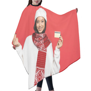 Personality  Smiling Asian Woman In Hat And Scarf Holding Credit Card And Showing Money Gesture Isolated On Red Hair Cutting Cape