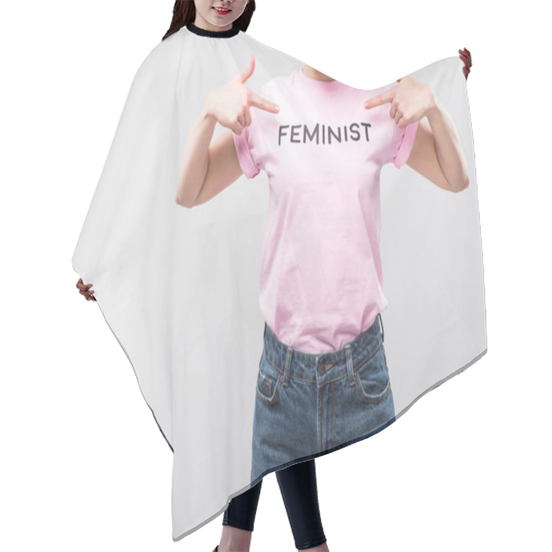 Personality  cropped view of woman pointing at pink feminist t-shirt, isolated on grey hair cutting cape
