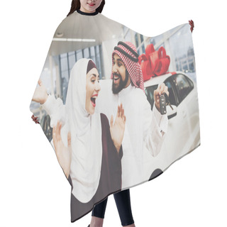 Personality  Arabic Couple At Car Dealership, Man Presenting New Car His Wife Hair Cutting Cape