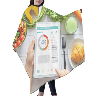 Personality  Calories Counting , Diet , Food Control And Weight Loss Concept. Woman Using Calorie Counter Application On Tablet At Dining Table With Fresh Vegetable Salad Hair Cutting Cape