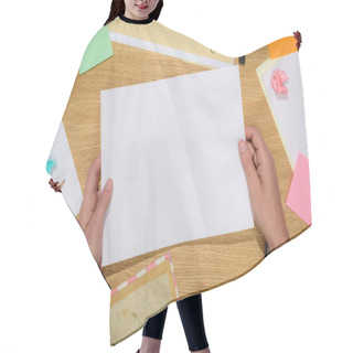 Personality  Cropped Image Of Woman Holding Empty White Paper Over Table With Stationery Supplies  Hair Cutting Cape