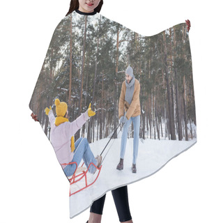 Personality  Smiling Man Pulling Girlfriend On Sled On Snow In Park  Hair Cutting Cape