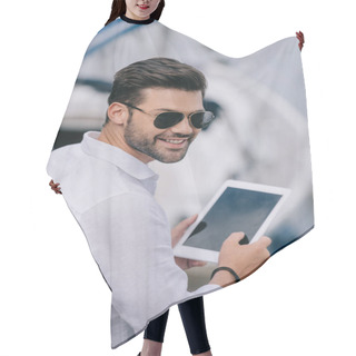Personality  Handsome Young Man In Sunglasses Smiling At Camera While Using Digital Tablet With Blank Screen Hair Cutting Cape