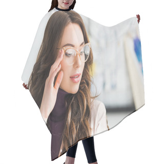 Personality  Attractive And Curly Young Woman Standing And Touching Glasses  Hair Cutting Cape