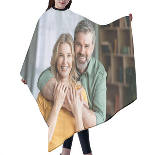 Personality  Portrait Of Loving Middle Aged Spouses Embracing And Smiling At Camera, Romantic Mature Couple Bonding While Posing In Living Room Interior, Enjoying Spending Time Together At Home, Copy Space Hair Cutting Cape