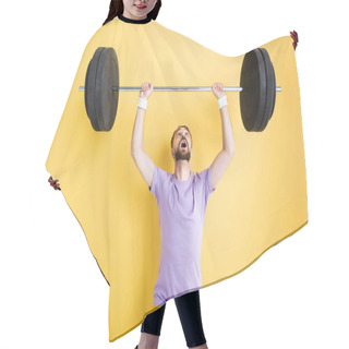 Personality  Surprised Bearded Sportsman Looking At Barbell While Working Out On Yellow Hair Cutting Cape