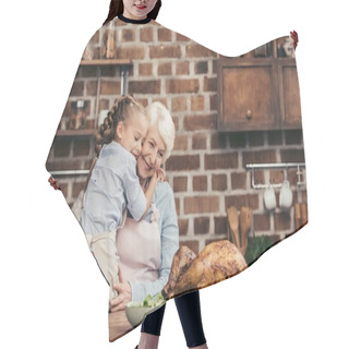 Personality  Grandmother And Granddaughter Embracing On Kitchen Hair Cutting Cape