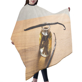 Personality  Vanilla Pods With Glass Bottle Of Essential Oil On Wooden Cutting Board Hair Cutting Cape