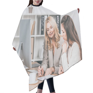 Personality  Smiling Female Business Mentor Pointing At Notebook And Working With Young Colleague In Office Hair Cutting Cape