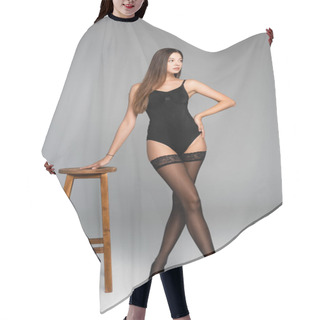 Personality  Sexy Woman With Hand On Hip, Wearing Bodysuit And Lace Stockings Leaning On Stool On Grey  Hair Cutting Cape