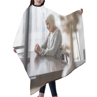 Personality  Pensive Senior Woman Sitting At Table And Holding Rosary Hair Cutting Cape