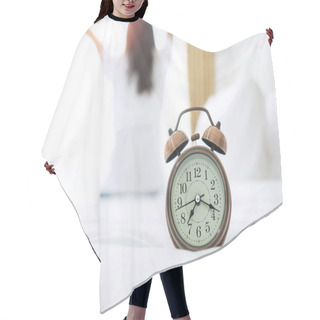 Personality  Closeup Alarm Clock With Background Of Happy Woman Stretching In Bed After Waking Up, Young Adult Female Rising Arms And Looking To Window In The Morning. Fresh Relax And Have A Nice Day Concepts Hair Cutting Cape