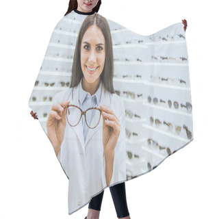 Personality  Professional Smiling Optometrist Holding Glasses In Ophthalmic Shop Hair Cutting Cape