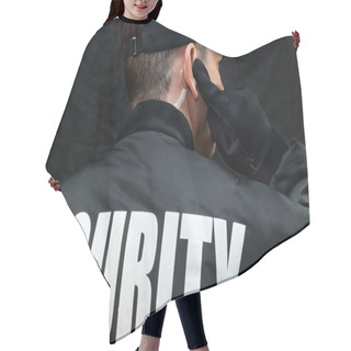 Personality  Security Guard Listens To Earpiece, Back Of Jacket Showing Hair Cutting Cape