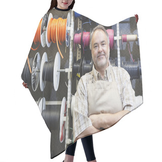 Personality  Portrait Of A Happy Mature Salesperson Standing In Front Of Electrical Wire Spool With Arms Crossed In Hardware Store Hair Cutting Cape