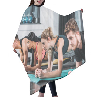 Personality  Concentrated Sporty Young Men And Women Doing Plank Exercise On Yoga Mats In Gym  Hair Cutting Cape