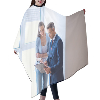 Personality  Handsome Broker Standing With Attractive Woman And Looking At Clipboard In Room  Hair Cutting Cape