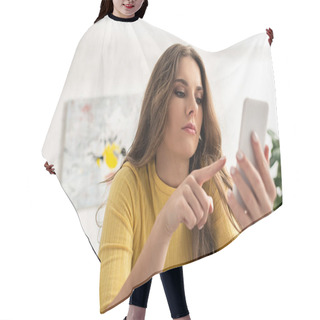Personality  Selective Focus Of Woman Pointing With Finger While Holding Smartphone On Couch  Hair Cutting Cape