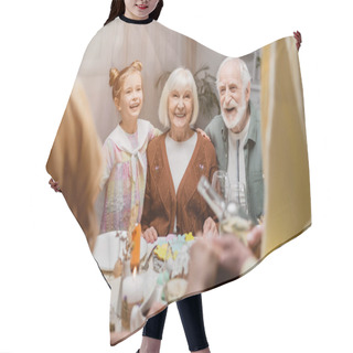 Personality  Cheerful Senior Couple Smiling Near Granddaughter And Family On Blurred Foreground Hair Cutting Cape