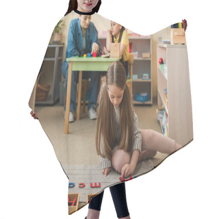 Personality  Girl On Floor Playing With Wooden Letters Near Asian Girl And Teacher On Blurred Background Hair Cutting Cape
