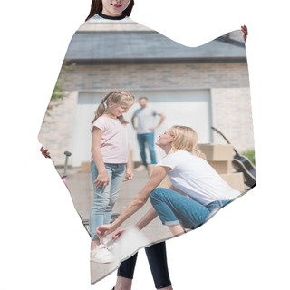 Personality  Smiling Woman Tying Shoelaces Of Daughter And Man Standing Behind Near Cardboard Boxes In Yard Of New Cottage  Hair Cutting Cape