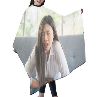 Personality  Unhappy Asian Woman Sitting On The Sofa And Holding On Stomach Suffering. Abdominal Pain That Comes From Menstruation, Diarrhea, Or Indigestion. Sickness And Healthcare Concept Hair Cutting Cape