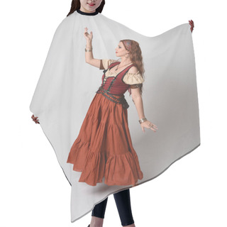 Personality  Full Length Portrait Of Beautiful Red Haired Woman Wearing A Medieval Maiden, Fortune Teller Costume. Standing Pose With Dancing Gestures, Twirling Skirt. Isolated On Studio Background. Hair Cutting Cape