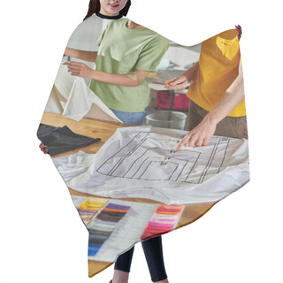 Personality  Cropped View Of Craftsman Holding Printing Sample And Pointing At T-shirt While Working With African American Colleague Near Laptop And Color Swatches In Print Studio, Small Business Success Concept Hair Cutting Cape