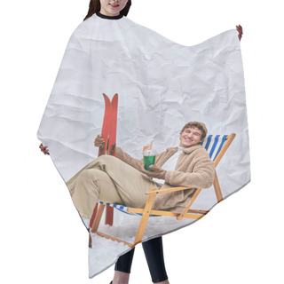 Personality  Cheerful Man In Winter Attire Sitting In Deck Chair With Apres-ski Beverage And Skis In Snowy Studio Hair Cutting Cape