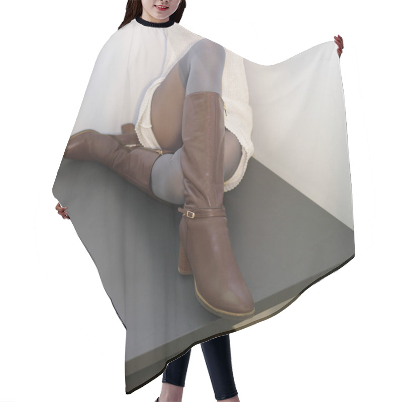Personality  Female Legs In Warm Pantihose And Boots Sitting On Table.  Hair Cutting Cape