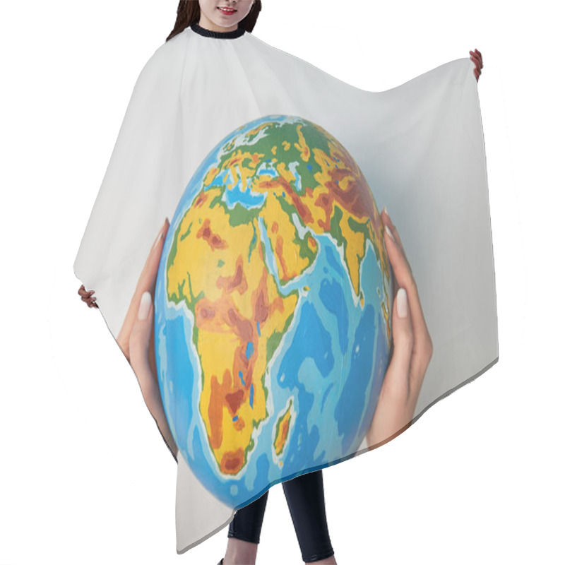 Personality  Cropped View Of Woman Holding Globe On White Background Hair Cutting Cape