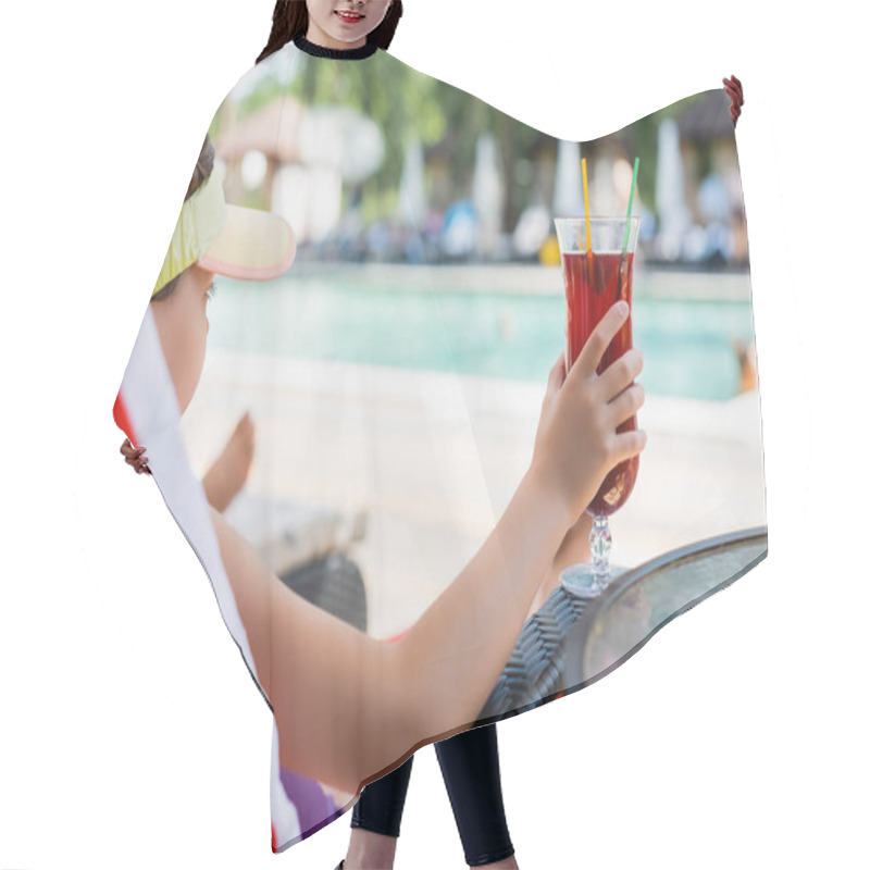 Personality  Selective Focus Of Girl In Sun Visor Cap Holding Cocktail Glass While Resting In Deck Chair Hair Cutting Cape