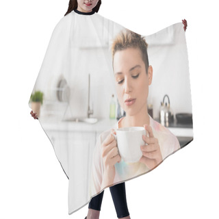 Personality  Young Bigender Person With Short Hair Holding Cup Of Tea In Blurred Kitchen Hair Cutting Cape
