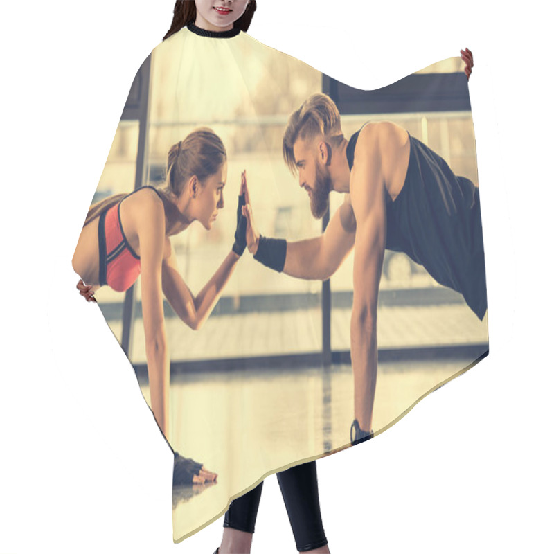Personality  Man And Woman Doing Plank Exercise  Hair Cutting Cape