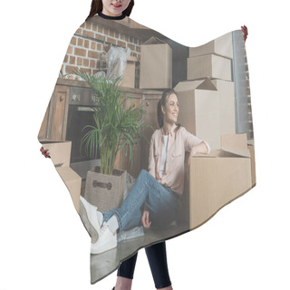 Personality  Happy Young Woman Smiling And Looking Away While Sitting With Cardboard Boxes In New Apartment Hair Cutting Cape