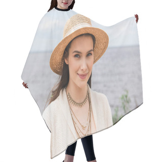 Personality  Pleased Young Woman In Sun Hat Looking At Camera Near Sea Hair Cutting Cape