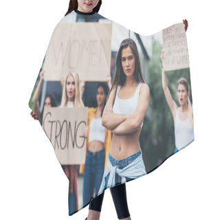 Personality  Serious Feminist Standing With Arms Closed Near Women Holding Placards With Feminist Slogans On Street Hair Cutting Cape