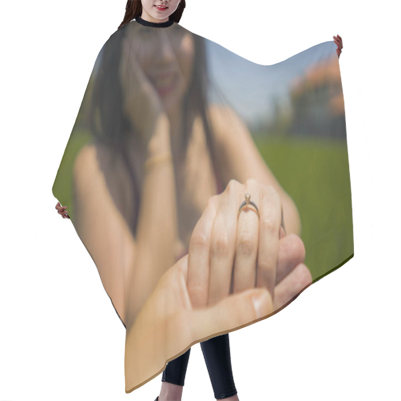 Personality  Romantic Marriage Proposal . Close Up Hands Of Happy Asian Couple In Love Holding Together , The Woman With Engagement Ring On Her Finger Isolated On Green Field Hair Cutting Cape