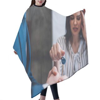 Personality  Selective Focus Of Upset Woman Giving Key To Collector With Clenched Hands  Hair Cutting Cape
