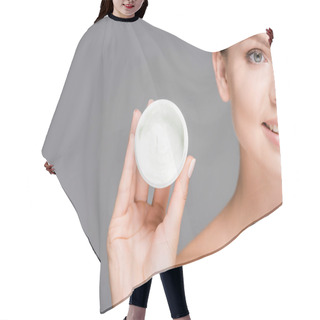 Personality  Cropped Shot Of Smiling Woman Holding Face Cream In Jar Isolated On Grey Hair Cutting Cape