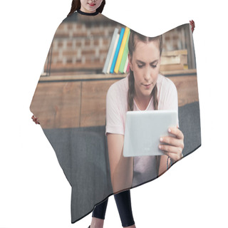Personality  Concentrated Teenage Girl Using Digital Tablet While Sitting On Sofa At Home Hair Cutting Cape