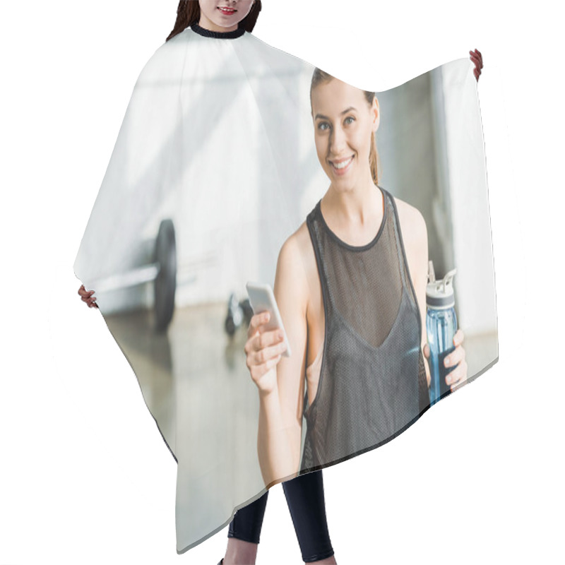Personality  Attractive Fit Sportswoman Holding Sport Bottle With Water And Using Smartphone At Sports Center Hair Cutting Cape