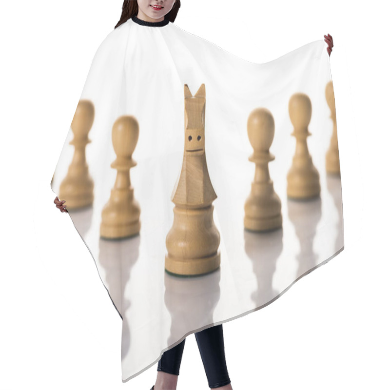 Personality  Selective focus of knight with pawns on white background hair cutting cape