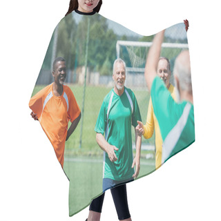 Personality  Selective Focus Of Multiracial Old Friends With Football Ball On Green Field Hair Cutting Cape
