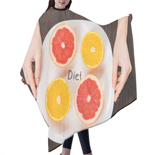 Personality  Cropped Shot Of Woman Holding Plate With Halved Citrus Fruits And Diet Inscription Hair Cutting Cape